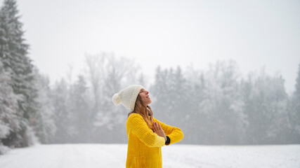 Young woman meditating in winter nature