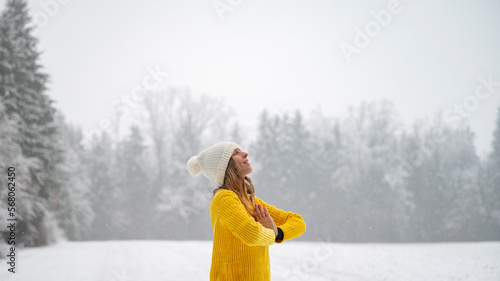 Young woman meditating in winter nature