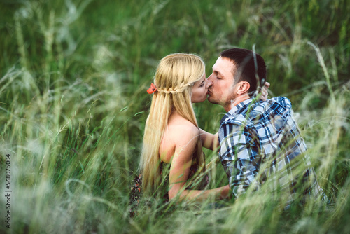 couple in love blonde girl and guy in the grass © omelnickiy