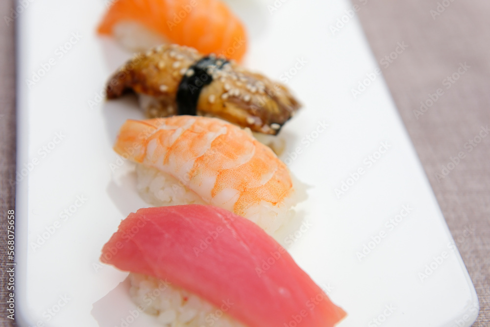 Sushi Set sashimi and sushi rolls served on white slate Tuna shrimp eel red fish salmon set of sashimi sushi with soy and chopsticks Asian Japanese food delicious restaurant beautiful serving Sushi Set sashimi and sushi rolls served on white slate Tuna shrimp eel red fish salmon set of sashimi sushi with soy and chopsticks Asian Japanese food delicious restaurant beautiful serving