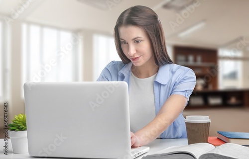 Serious young businesswoman sitting at work in office