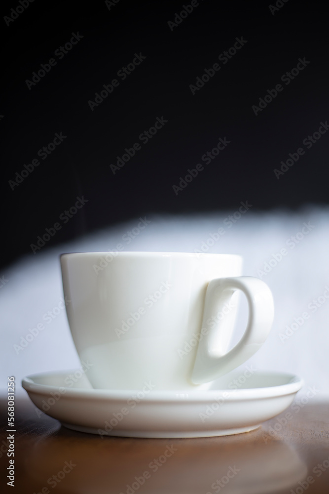 White cup hot drinking with steam on pine wooden table
White cup hot drinking with steam on pine wooden table
