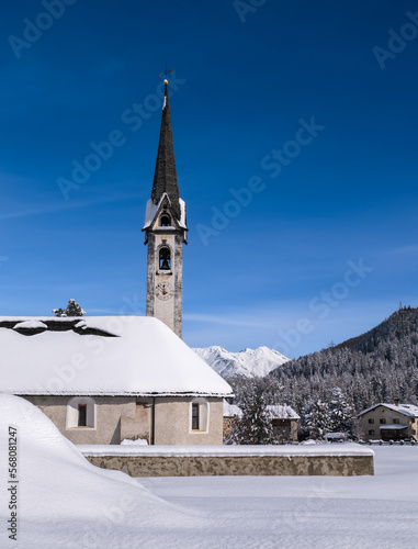 Reformed church in the snowy village of Cinuos Chel in the Engadin, Graubunden, Switzerland