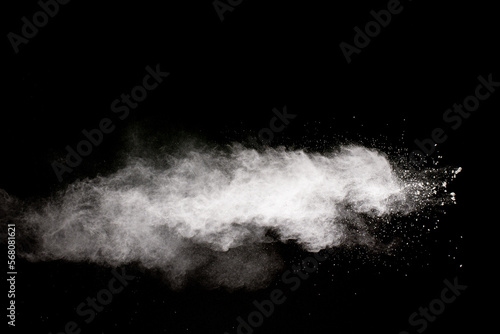 White powder explosion cloud against black background.White dust particle splash.