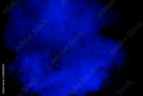 Blue powder explosion cloud on black background.Launched blue dust particle splash. © Pattadis