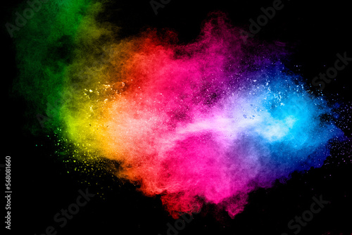 Launched multicolored powder on black background.Colorful dust splashing. © Pattadis