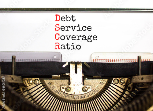 DSCR debt service coverage ratio symbol. Concept words DSCR debt service coverage ratio on retro typewriter on beautiful white background. Business DSCR debt service coverage ratio concept. Copy space photo