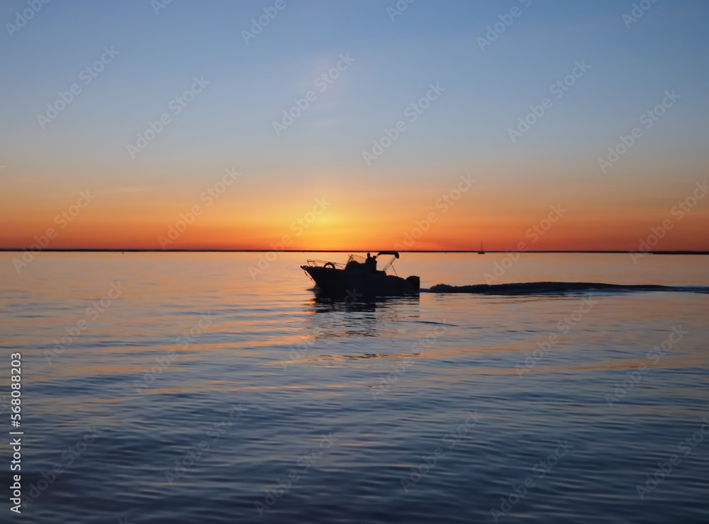 Beautiful sunset above the ocean with a boat