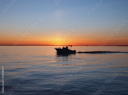 Beautiful sunset above the ocean with a boat © Stimmungsbilder1