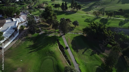 golf cart drives through the courses view from a drone photo
