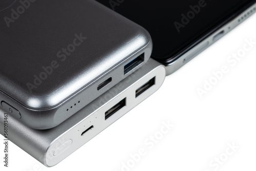 Powerbank for charging mobile devices on white. Smartphone with power bank. External battery for mobile devices