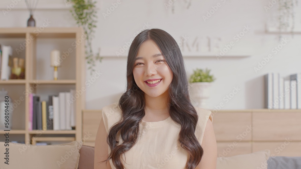 Portrait of happy beautiful asian woman look at camera smile with positive emotional.Smart confident freelance woman smiling happiness with work at home or study young woman video call study online.