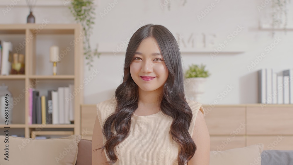 Portrait of happy beautiful asian woman look at camera smile with positive emotional.Smart confident freelance woman smiling happiness with work at home or study young woman video call study online.
