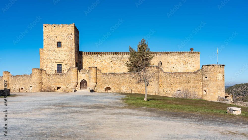 Panoramic view of the impressive medieval castle of Pedraza on a sunny day with blue sky, Segovia, Spain.