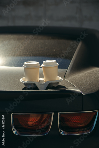 cups of coffee on black sport car Chevrolet Camaro