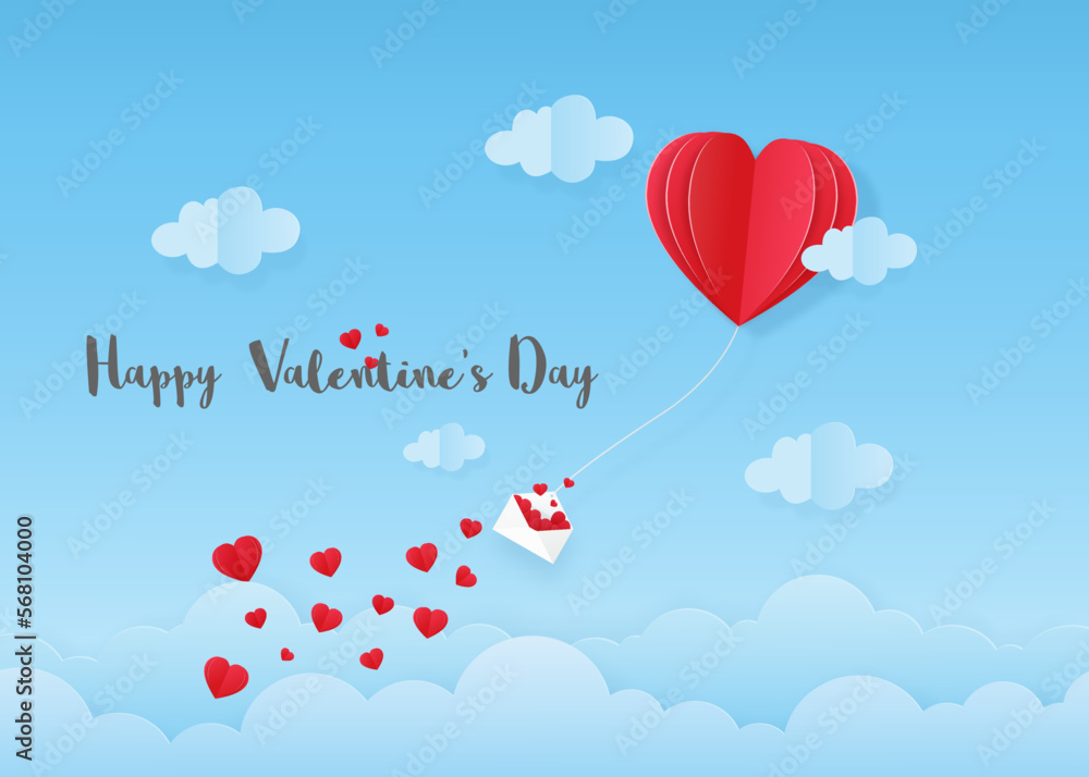 Pink heart air balloon and envelope with paper cut hearts floating on blue sky background.