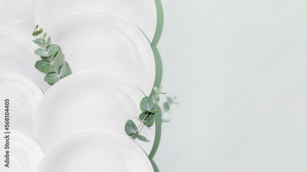 Clean, empty white dishes with eucalyptus twigs on blue background with copy space. Eco friendly washing dishes and cleaning. Dishes, porcelain background. Flat lay Clean, empty white dishes with eucalyptus twigs on blue background with copy space. Eco friendly washing dishes and cleaning. Dishes, porcelain background. Flat lay