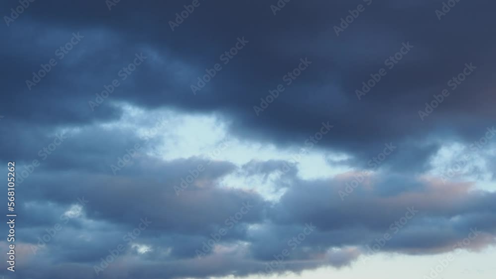 Timelapse gray clouds float across the dark sky on a cloudy day. Cloudy skies and gloomy clouds. Magic dramatic sky. Ominous clouds are slowly moving across the sky. Timelapse gray clouds float across the dark sky on a cloudy day. Cloudy skies and gloomy clouds. Magic dramatic sky. Ominous clouds are slowly moving across the sky.