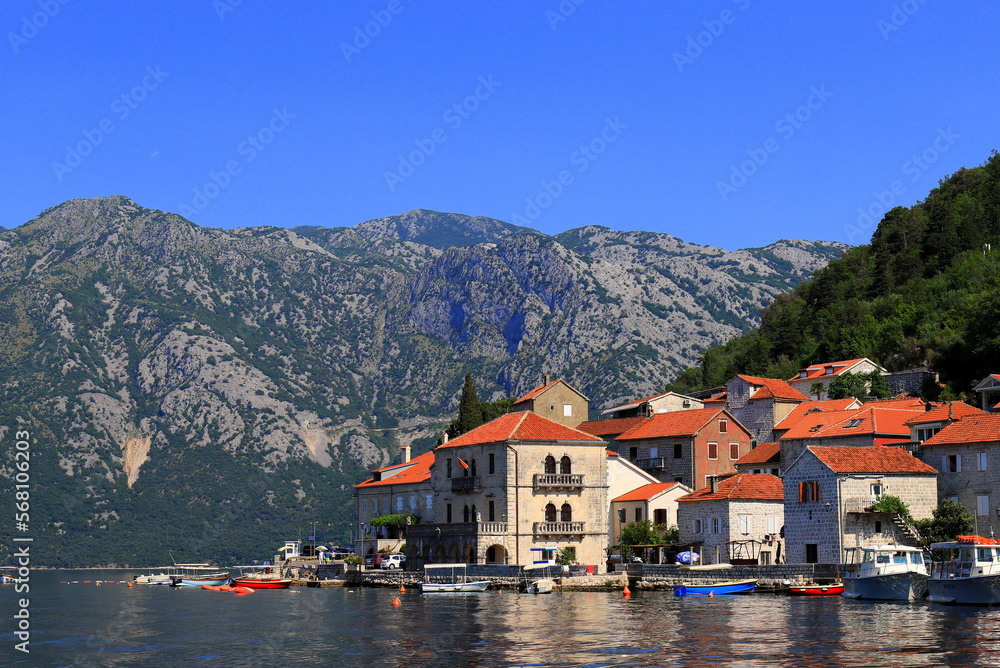 Perast Montenegro. Old Historic buildings, beautiful resort town in Kotor Bay in summer near high mountains. Montenegro