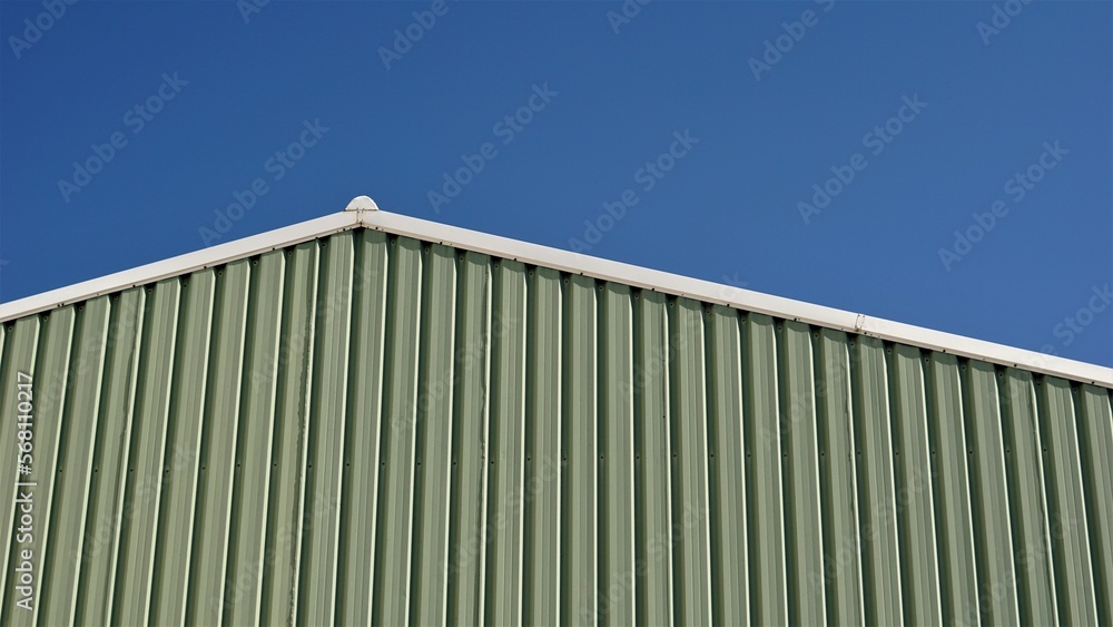 roof of industrial warehouse building against the sky