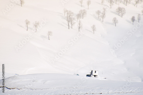Snowcat with cabin to take skiers snowboarders freeride downhill in remote caucasus mountains. Ratrak in