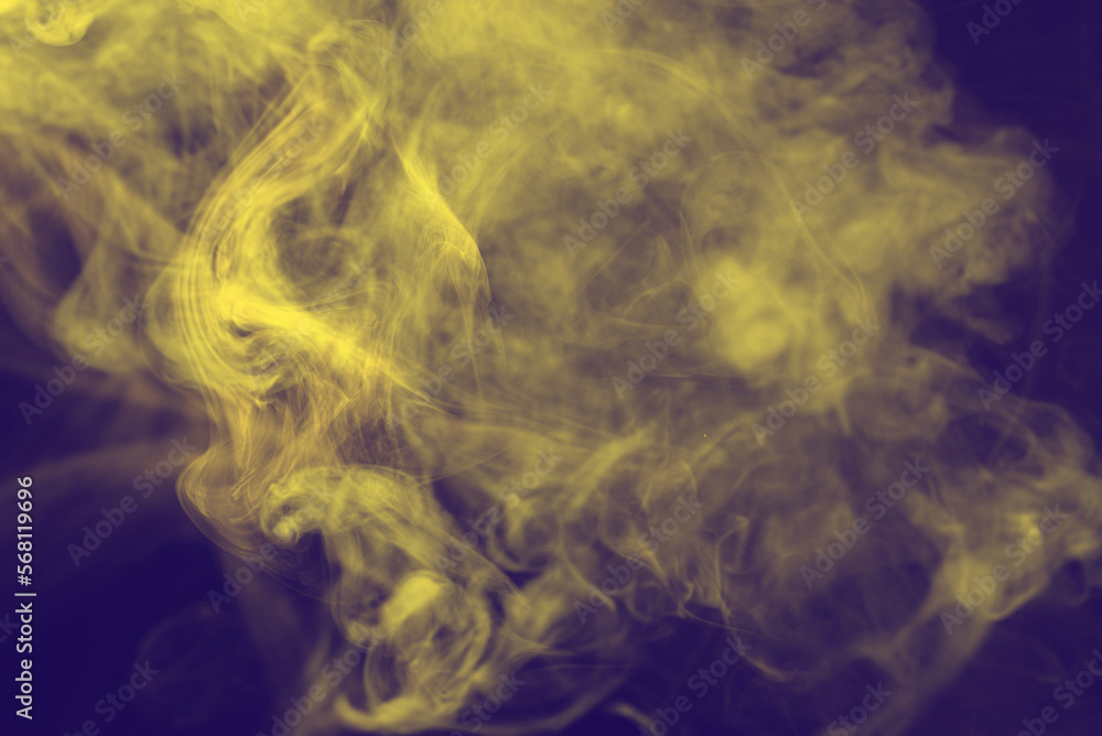Obraz premium Yellow steam on a black background.