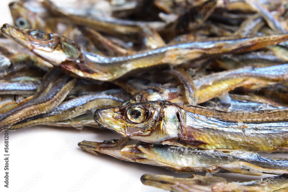 Dried sardines treats for dogs and cats. Close up of many dehydrated fishes in multiple sizes. Healthy dog snack or health supplement rich on protein, omega 3 and 6 and calcium. Selective focus. Dried sardines treats for dogs and cats. Close up of many dehydrated fishes in multiple sizes. Healthy dog snack or health supplement rich on protein, omega 3 and 6 and calcium. Selective focus.