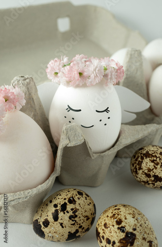 Fototapeta Naklejka Na Ścianę i Meble -  An angel made of an egg sits in an egg box. Easter decoration.