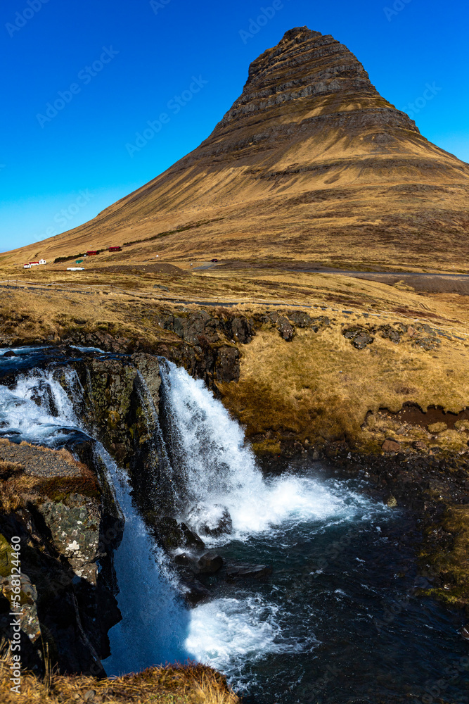 Famous Kirkjufell unique shaped Kirkjufell mountain and beautiful waterfall during spring season. Snæfellsnes peninsula, Iceland