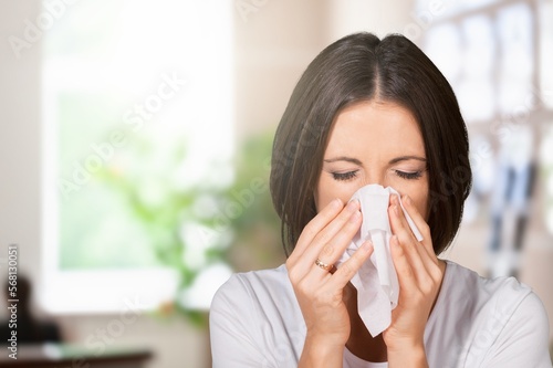 Sick young woman with fever use tissues