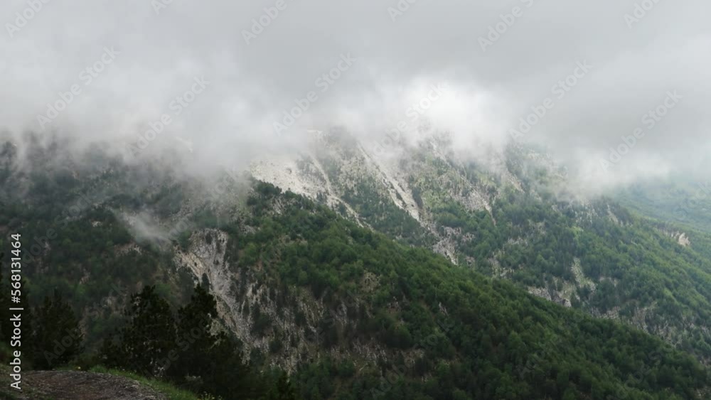 epic storm and clouds movements in a green valley between high moutains epic storm and clouds movements in a green valley between high moutains