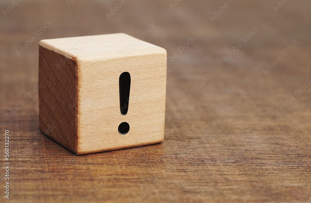 exclamation mark drawn on wooden block with copy space on the wooden floor.
exclamation mark drawn on wooden block with copy space on the wooden floor.