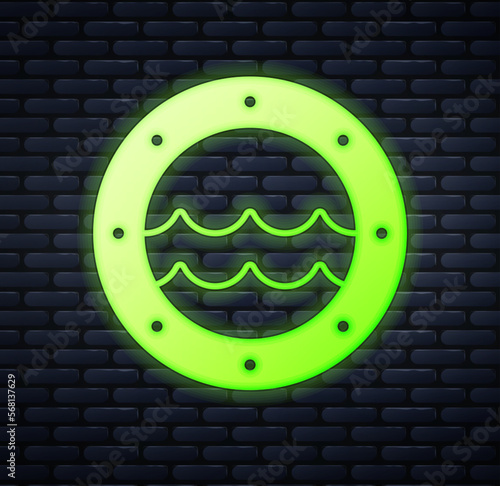 Glowing neon Ship porthole with rivets and seascape outside icon isolated on brick wall background. Vector