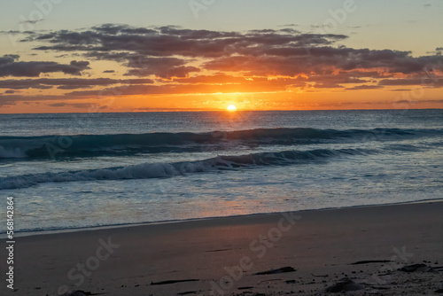 Waves from the Atlantic Ocean crash on the fossilized coral rocks of Singer Island Florida at sunrise