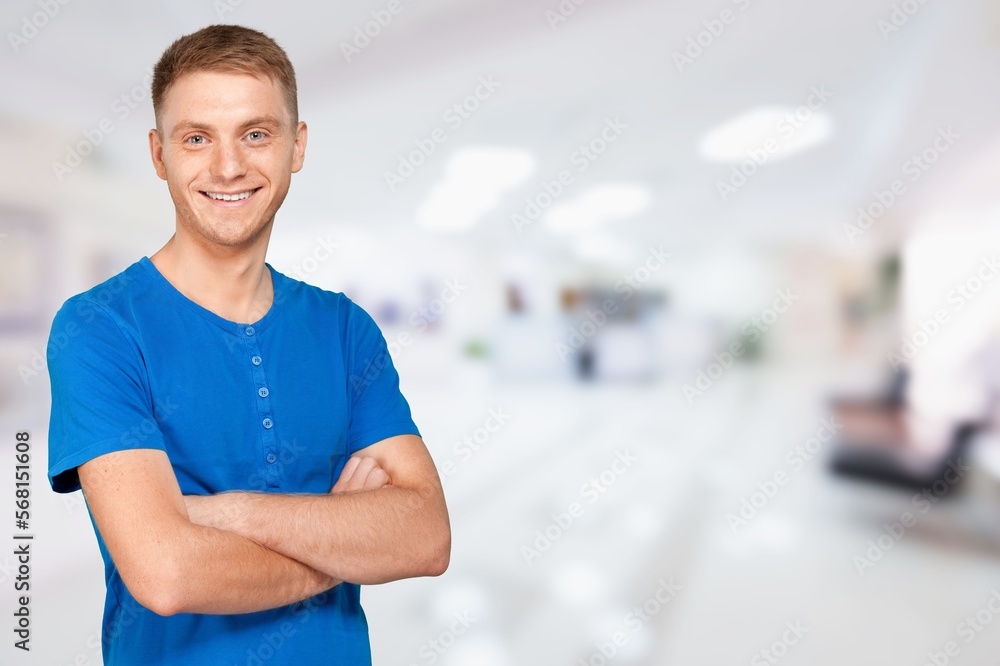Fototapeta premium Smiling young man posing with hands crossed