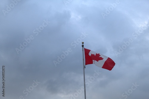 Canadian flag with overcast sky