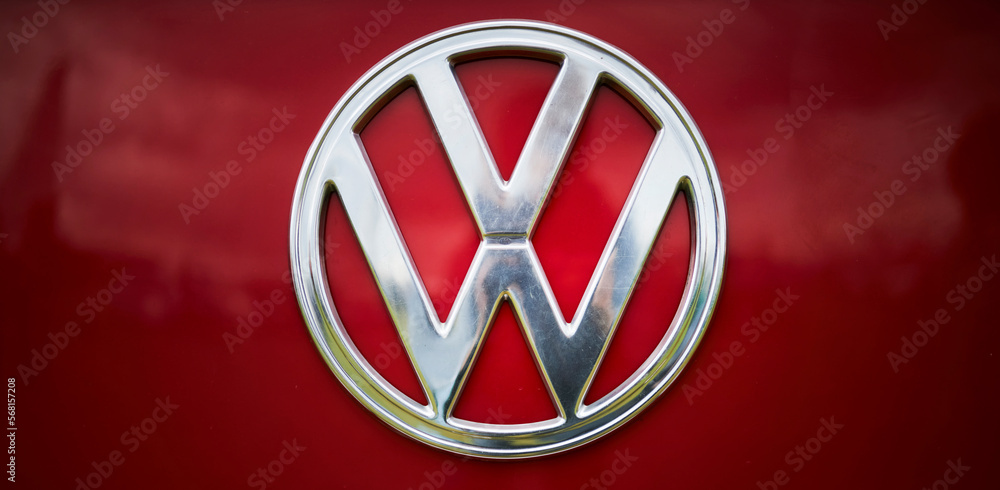 Kyiv, Ukraine - May 29, 2021: Volkswagen car front logo over red paint.  Image of the vintage Volkswagen logo. Volkswagen logo on a red background,  closeup foto de Stock