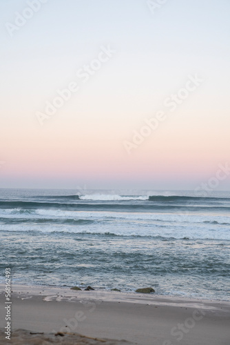 waves in the sea while sunrise on the beach