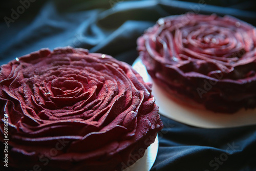Mousse cake in the shape of a red rose on a dark background