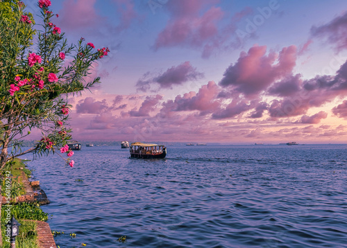 Beautiful landscape with a house boating in marine drive, Kochi, India. Travel and tourism Kerala - houseboat on Alleppey backwaters in India. Kerala houseboat image. High quality photo