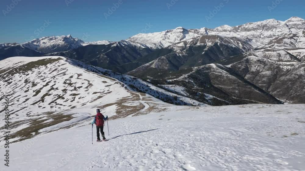 Mountaineer going down with snowshoes. Huesca Pyrenees Mountaineer going down with snowshoes. Huesca Pyrenees