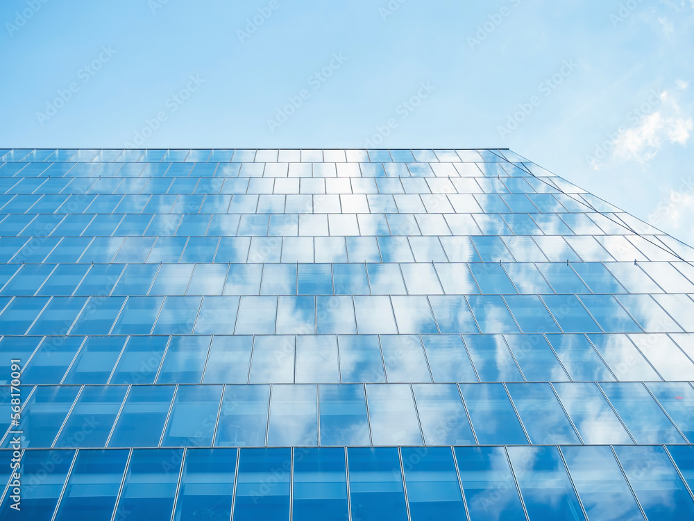 The sky with white clouds reflecting in the glass windows of a modern office building. The sky with white clouds reflecting in the glass windows of a modern office building.