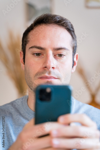 Young man with smartphone looking the news