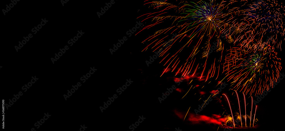 Fireworks on a black background. Fireworks banner. Copy space. New Year and Celebration banner. Sparks salute isolated on black background. Festive banner with flashes of fireworks