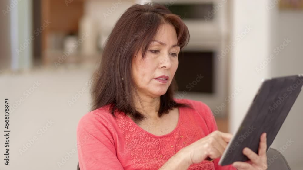 Attractive woman shopping online with mobile tablet and e-commerce credit card smiles excited at buying success sitting in comfortable home has healthy lifestyle Attractive woman shopping online with mobile tablet and e-commerce credit card smiles excited at buying success sitting in comfortable home has healthy lifestyle