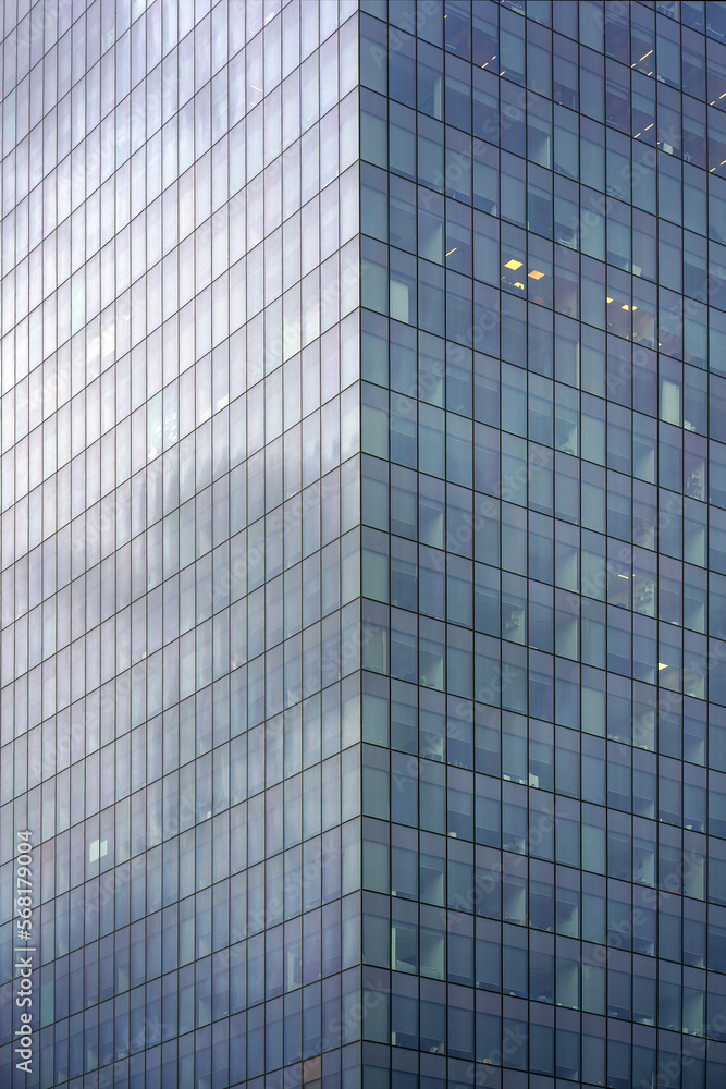 Abstract architecture. Angle modern business building skyscraper blue glass. Glass blue square Windows of facade modern city business building skyscraper Abstract architecture. Angle modern business building skyscraper blue glass. Glass blue square Windows of facade modern city business building skyscraper