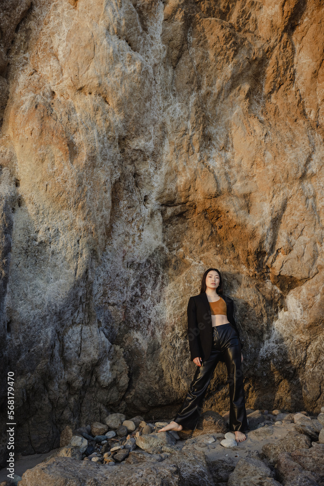 Model standing near the rock. Mika Nakano