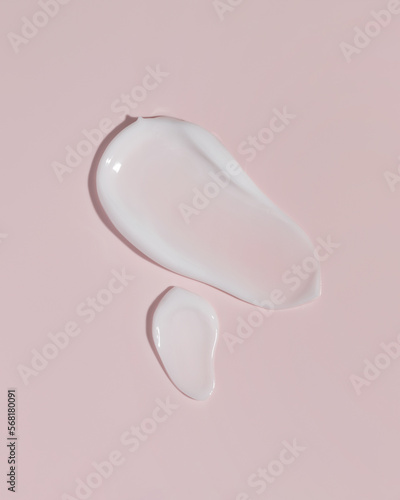 Cosmetic smears cream texture on pink background. Cosmetic skincare product texture. Face cream, body lotion swipe swatch