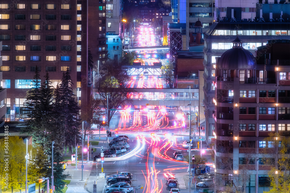 View of the night city. Street and transport. Blurred car lights. Traffic. Wallpaper and background. Skyscrapers and business centers.