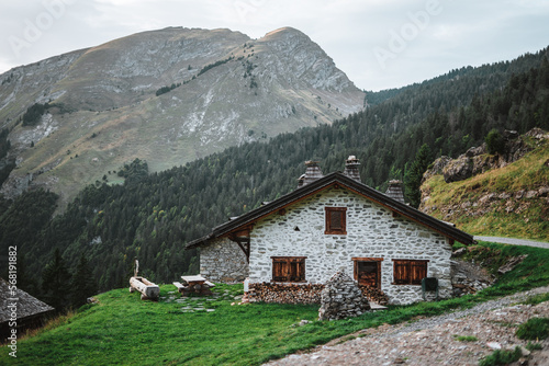 Wooden hut in the alps with mountains in the background Panorama